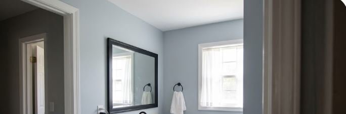 finished bathroom with navy vanity